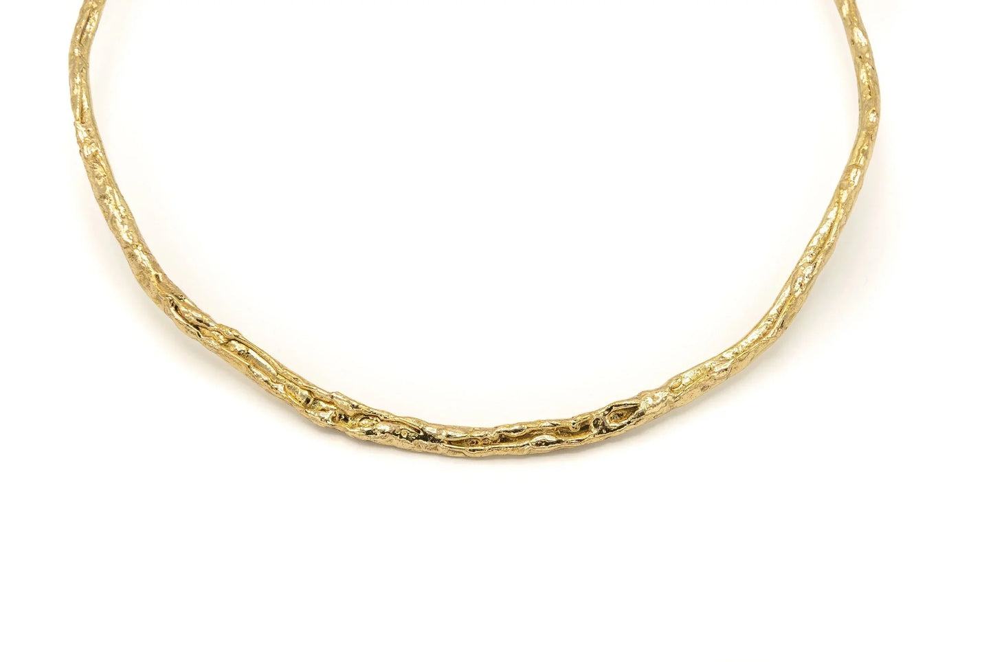 Handmade gold textured choker necklace with organic design on white background