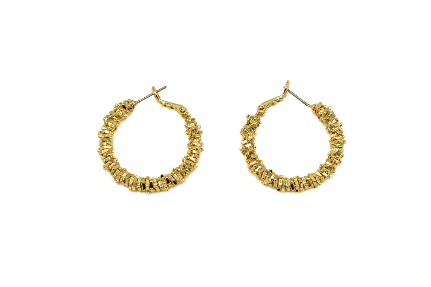 Gold textured hoop earrings with bead accents on white background