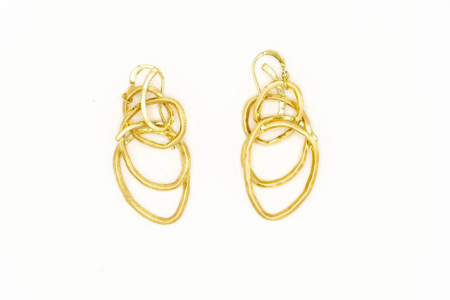 Gold-tone earrings with twisted, interlocking wire loops on a white background