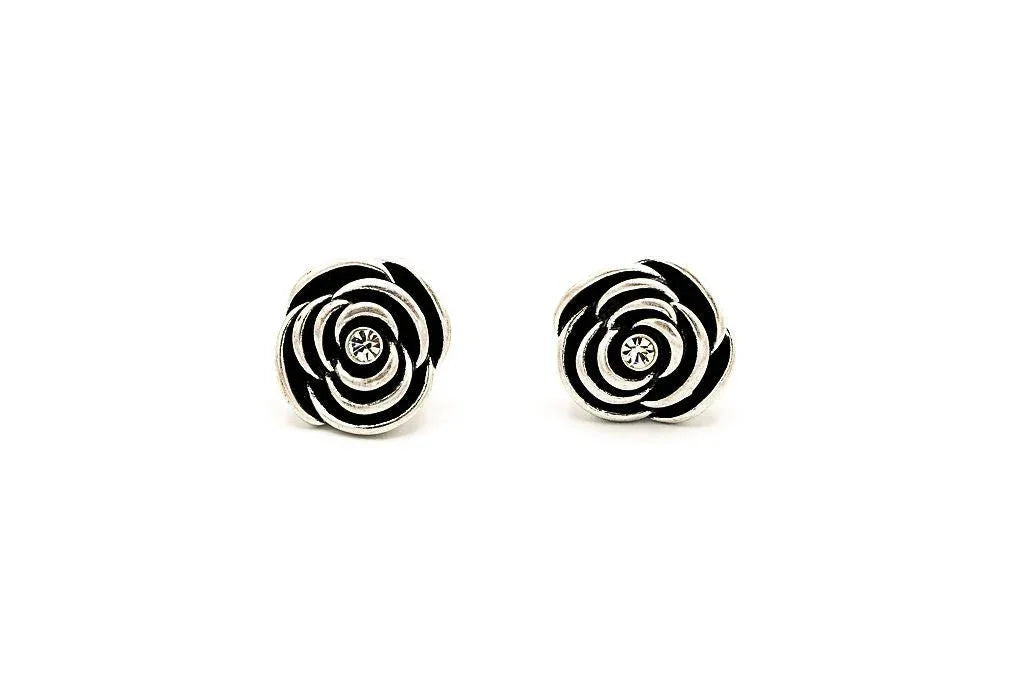 Rose-shaped stud earrings with silver-tone metal and central rhinestone on white background