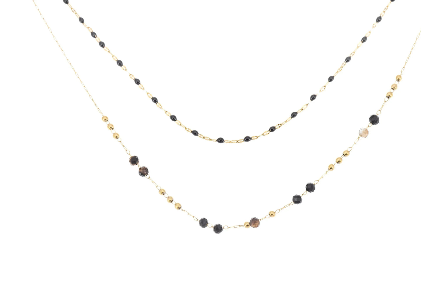 Layered gold chain necklace with black and brown crystal beads on white background