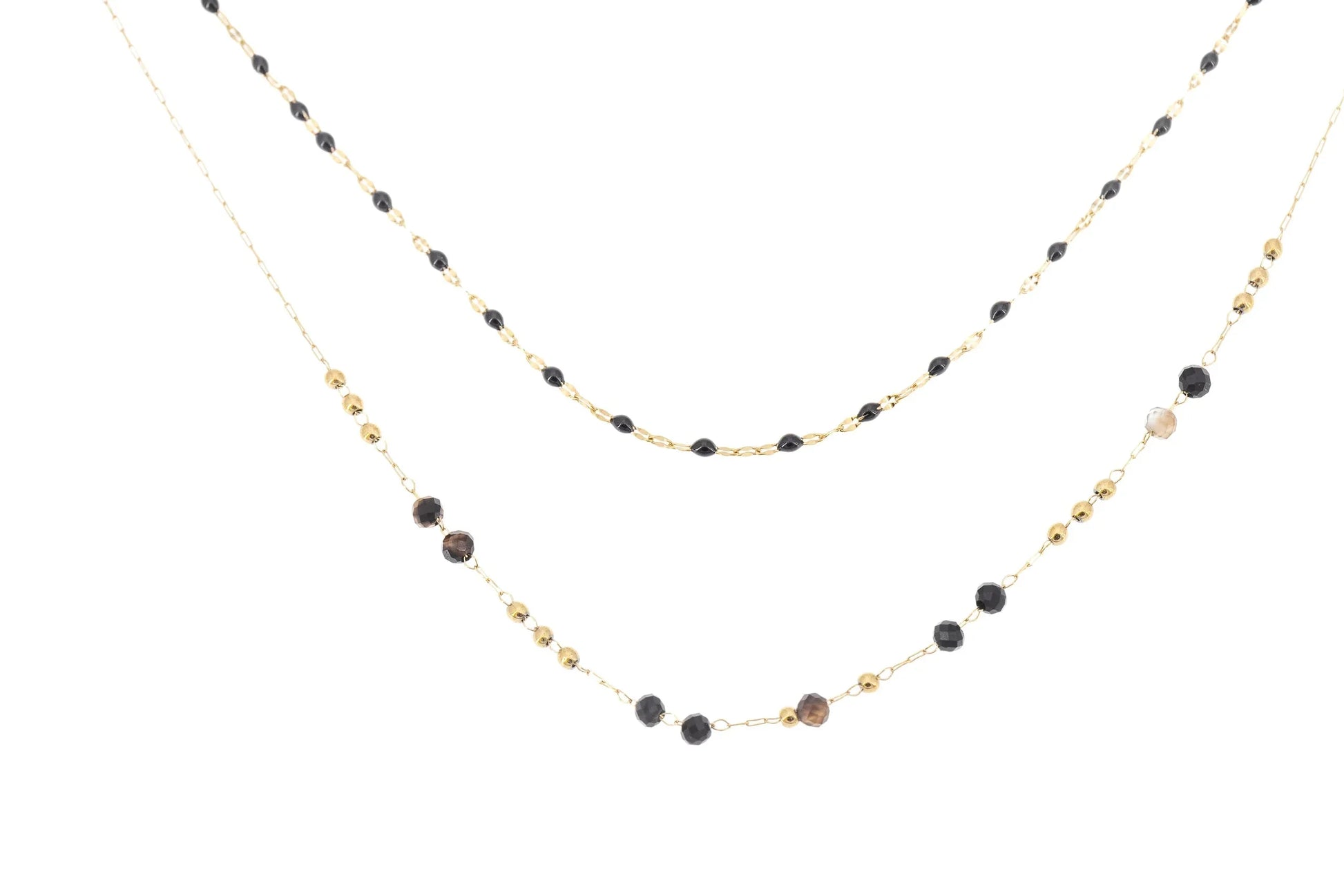 Layered gold chain necklace with black and brown crystal beads on white background