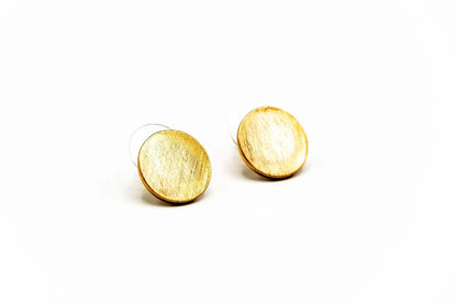Round gold stud earrings with brushed texture on white background
